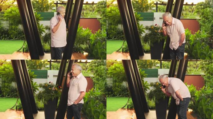快乐的印度老人，白发老人走在户外，拿着手机享受有趣愉快的谈话。老一辈人利用现代无线技术进行远程通信