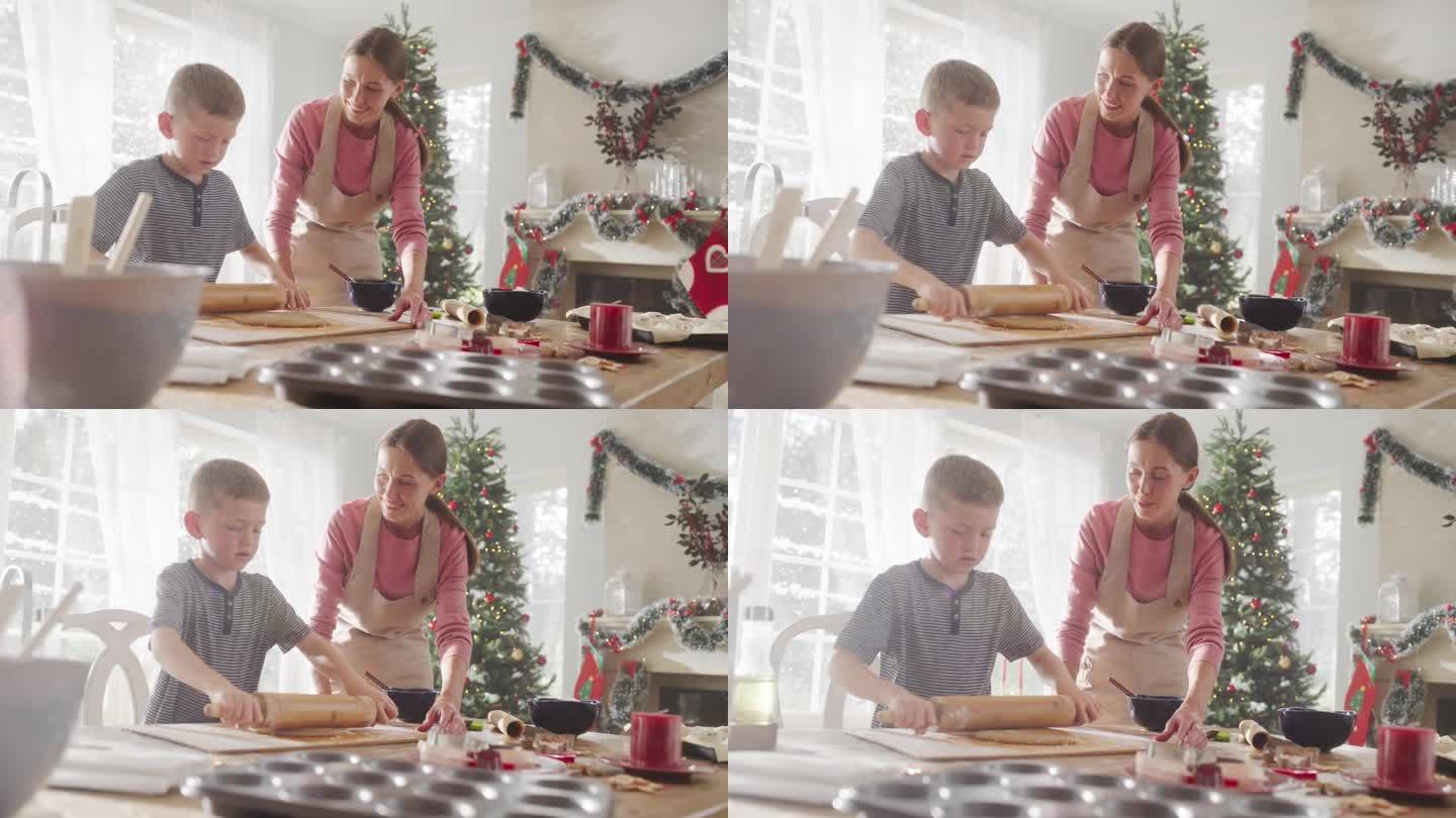 一个女人和她的儿子在圣诞节期间一起烘焙的慢动作肖像。妈妈教她的小男孩如何做姜饼饼干。孩子在假期帮妈妈