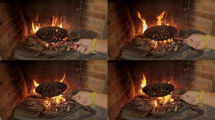 用穿了洞的平底锅在火上煮栗子时摇晃栗子