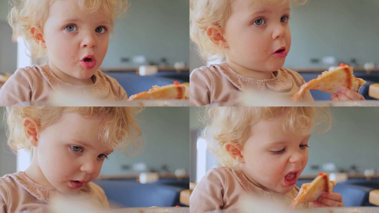 金发女婴吃披萨的特写，咬着美味的快餐，饿着肚子独自坐在披萨店或垃圾食品店。