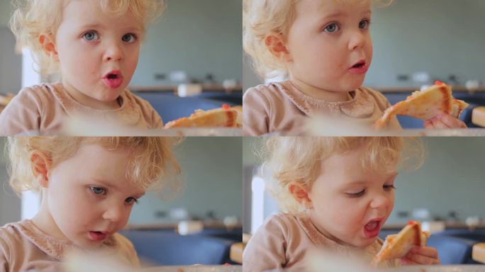 金发女婴吃披萨的特写，咬着美味的快餐，饿着肚子独自坐在披萨店或垃圾食品店。