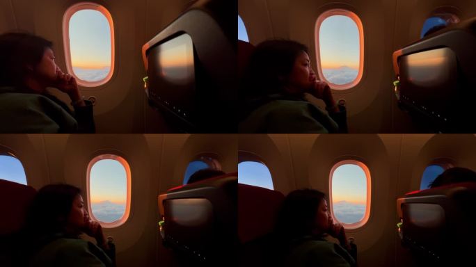 一名女子坐在飞机上，在日落时分看着窗外
