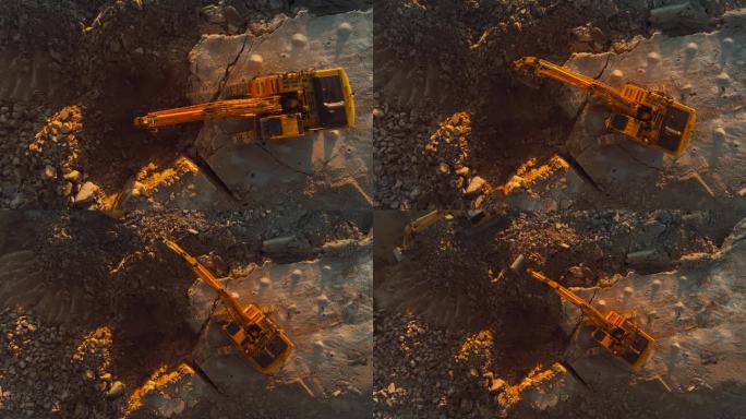 在阳光明媚的日子里，无人机直接拍摄了在建筑工地挖掘岩石的工业挖掘机。操作重型机械完成房地产项目或开采
