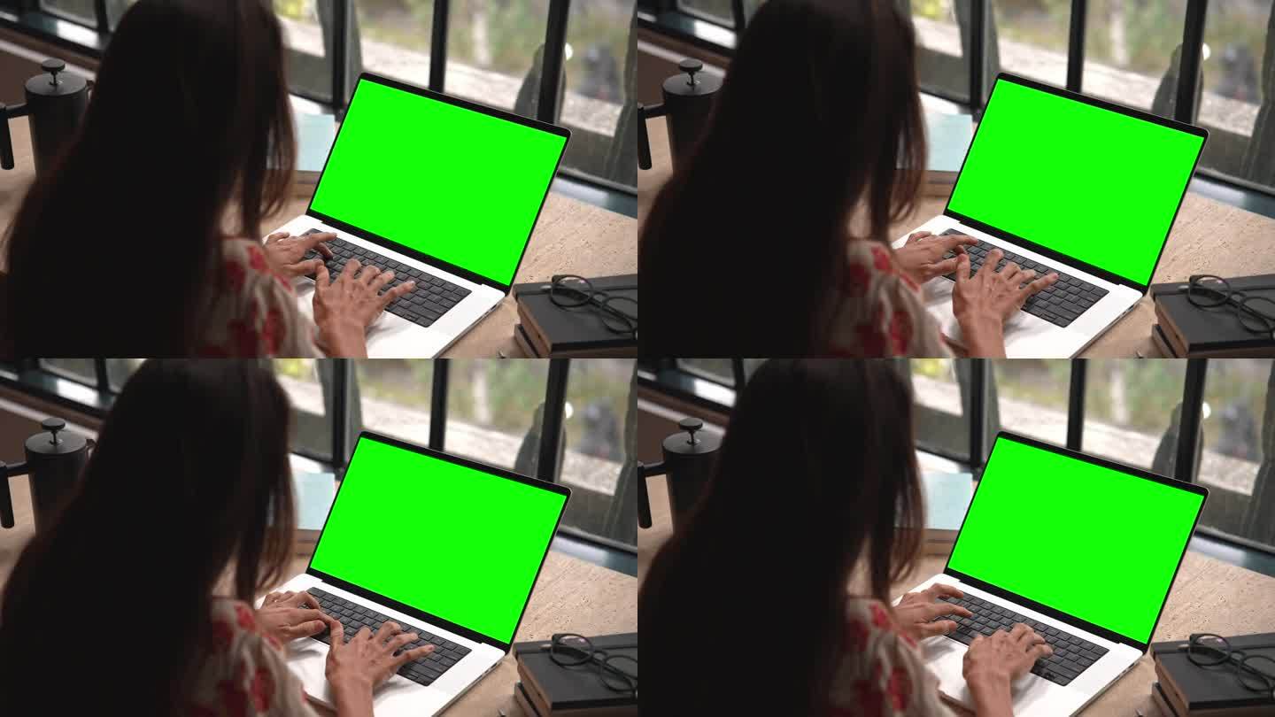 女人工作在笔记本电脑模拟绿屏色度键和键盘上输入文本特写。在网上聊天或写文件特写的女性。程序员在电子邮