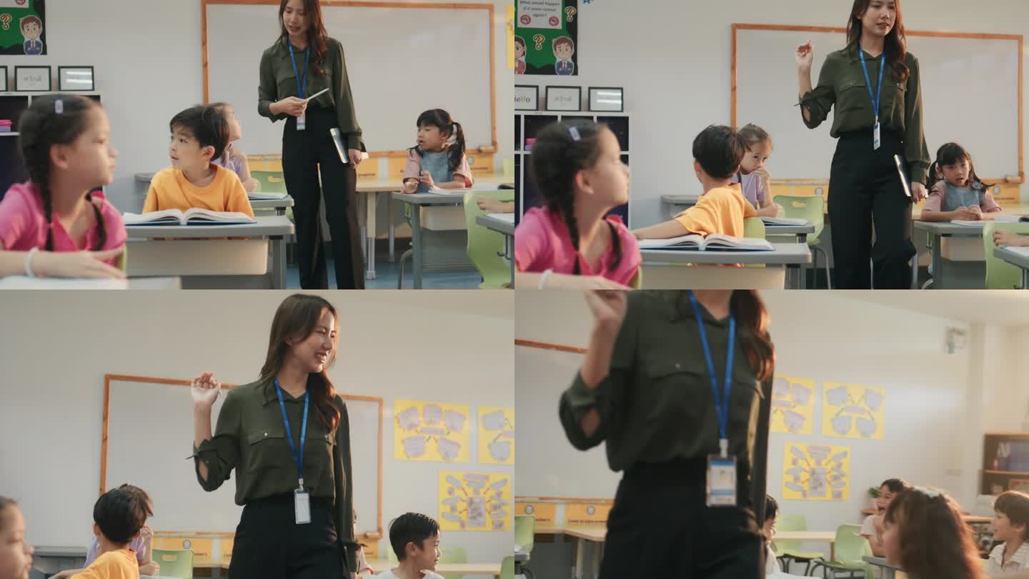 漂亮的亚洲女老师在教室里走来走去，而孩子们坐在桌子旁