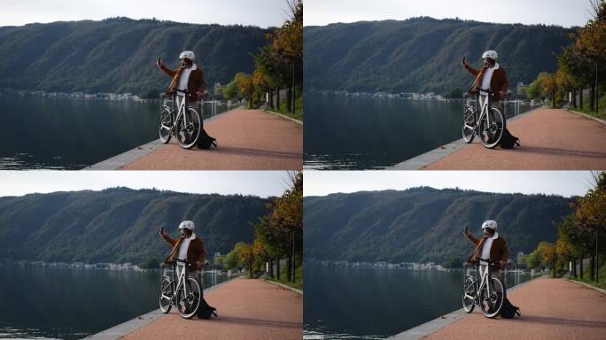 城市骑行，电动自行车通勤者捕捉到湖边的景色
