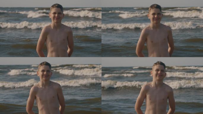 男孩在海滩上微笑。海的背后