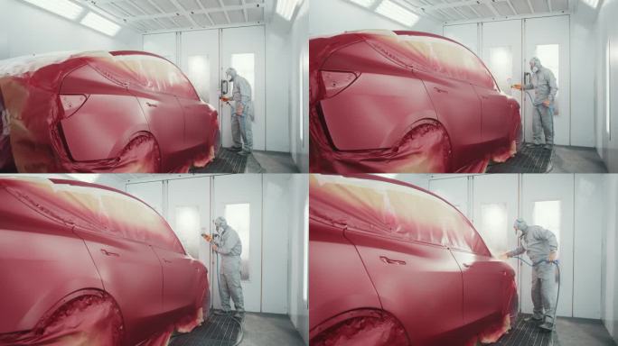 汽车修理。人喷漆车在特殊的汽车室红色。汽车服务站。工人在特殊车库为红色电动汽车喷漆，穿着工作服和防护