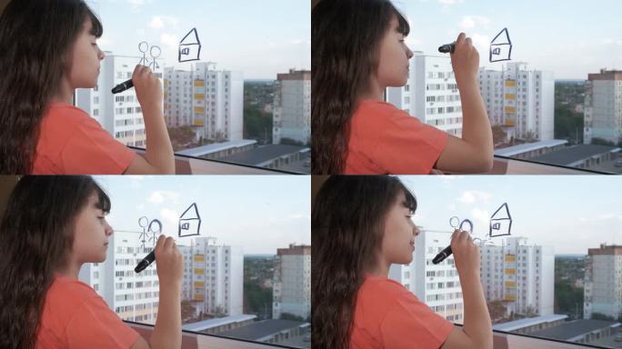 孩子用毛笔在窗户上画画。