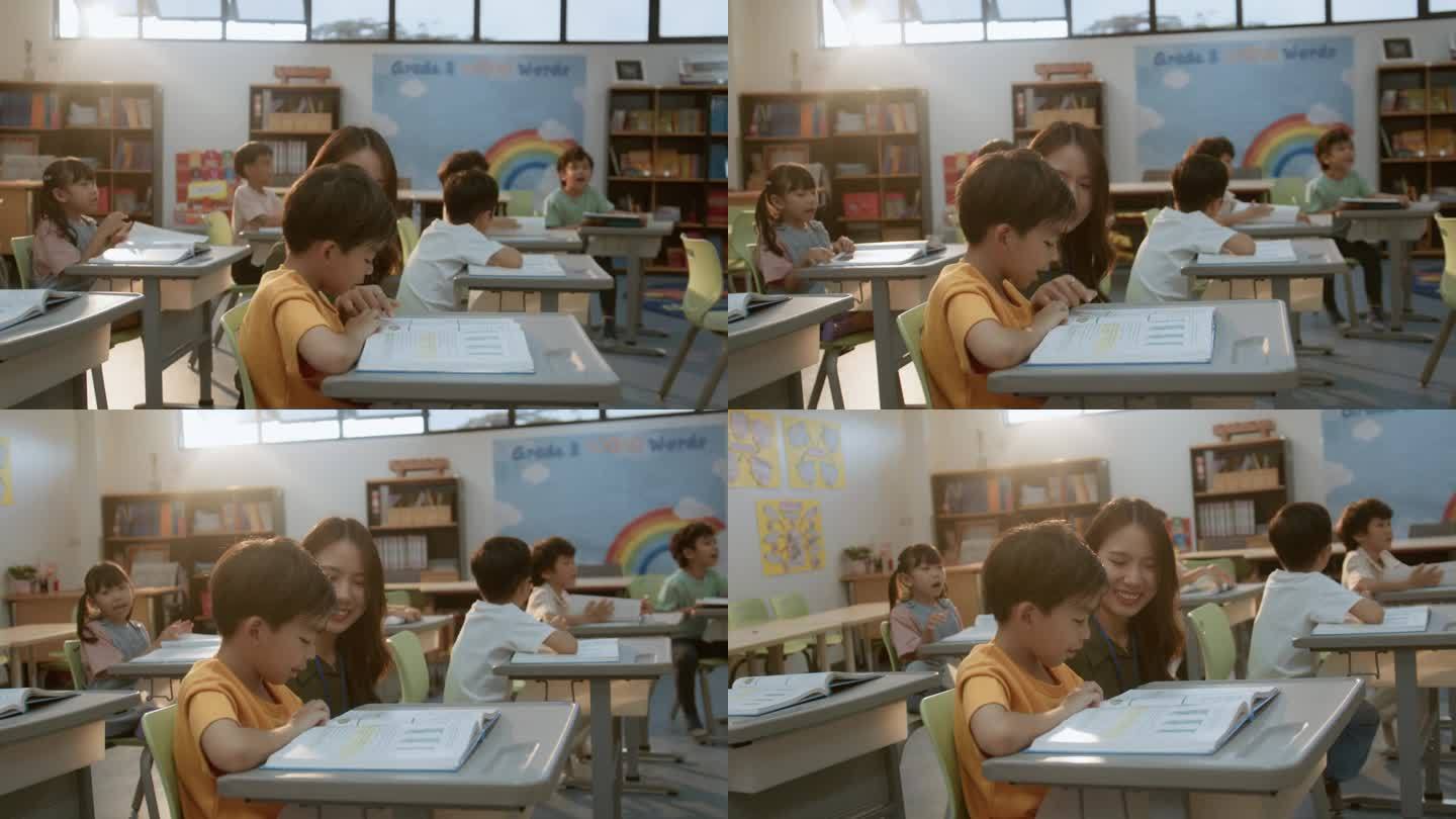 快乐的亚洲女教师在小学帮助她的学生上课。