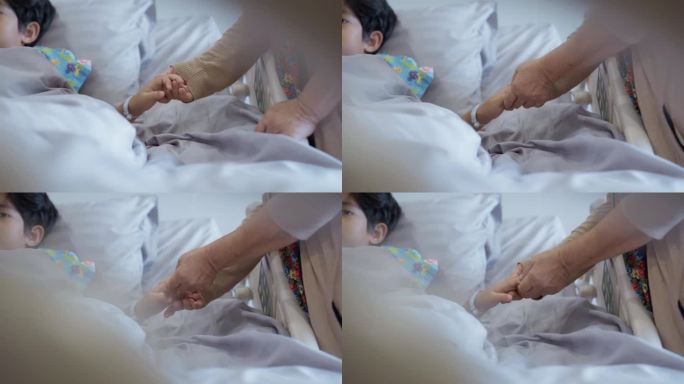 一位祖母握着因流感躺在医院病床上的孙子的手。