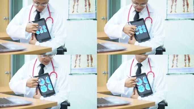 医生用电子平板电脑与病人讨论脑部扫描