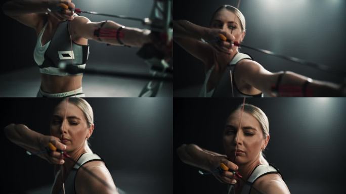 一名女射手手持现代复合弓瞄准目标的电影肖像。年轻运动员在体育场比赛或在黑暗的广告工作室画箭