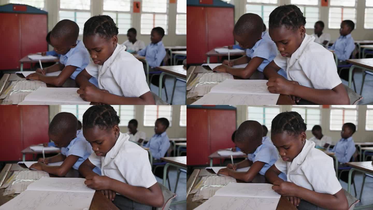 特写镜头。非洲黑人学生在教室的课桌上画画