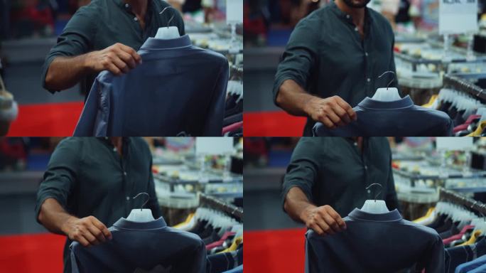 在一个时髦的购物中心，一位英俊的年轻男子正在检查一件挂在衣架上的休闲衬衫。一个年轻人在一家时尚男装店