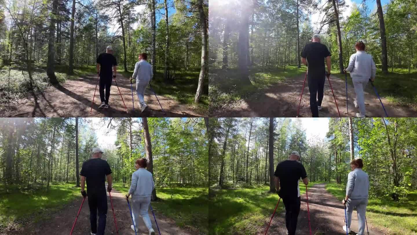 活跃的老年人在森林里拄着杆子散步