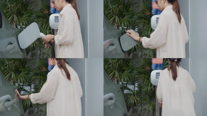 亚洲女性从充电站断开电动汽车的充电电缆。