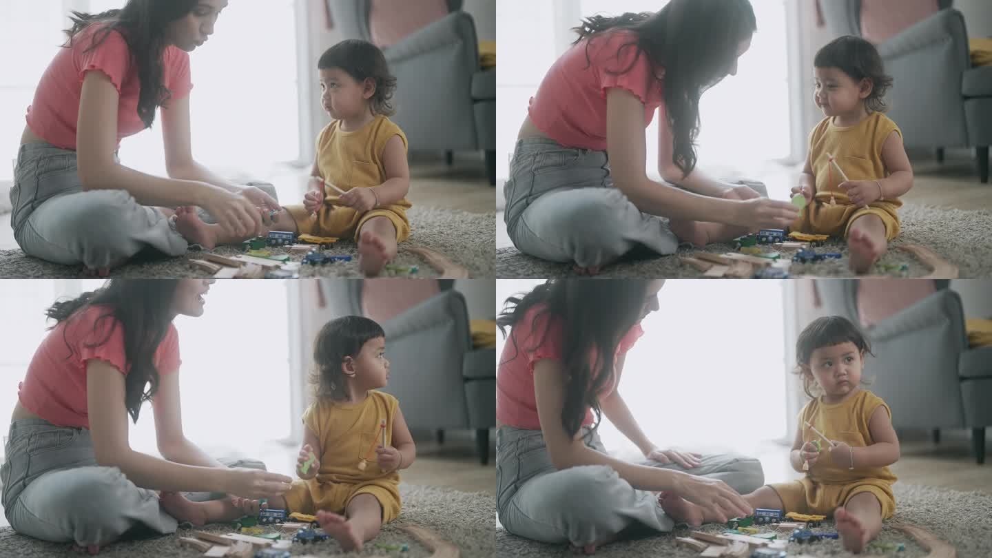 亚洲妈妈和小女孩在客厅里学习玩五颜六色的木制玩具
