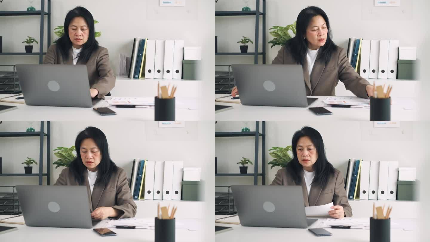 亚洲女商人在现代办公室用笔记本电脑做营销计划