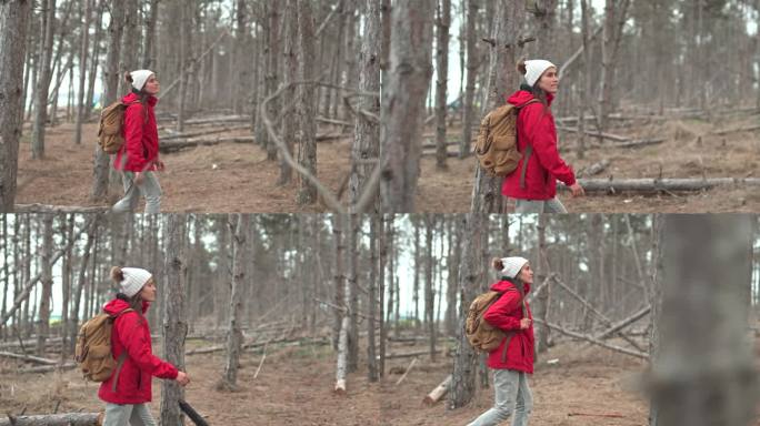 穿红衣服的女人在树林里徒步旅行。回归自然。