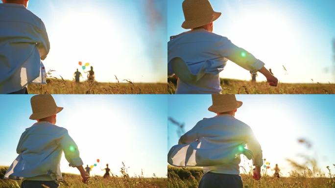 幸福家庭户外理念。夕阳西下，小男孩跟在父母身后跑在田野中央。人们在夏天一起在户外玩耍，乡村。