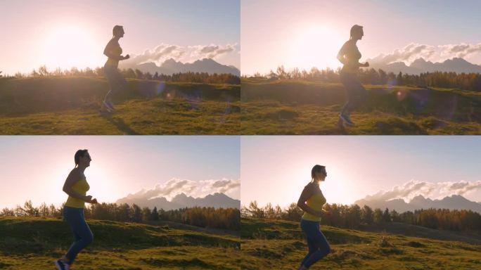 特写，镜头光晕:穿着运动服的运动女子在长满草的山脊上奔跑