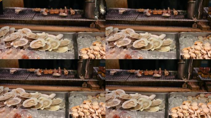 大阪鱼市街的街头小吃，用煤烤的扇贝
