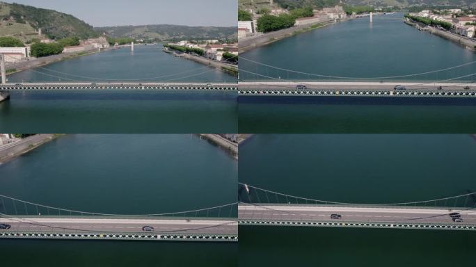 飞向行驶在法国罗纳河上的Gustave Toursier桥上的汽车。——空中