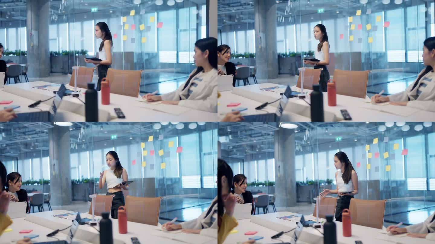 年轻的亚洲女性和团队在办公室一起工作到很晚的时候开会和集思广益。
