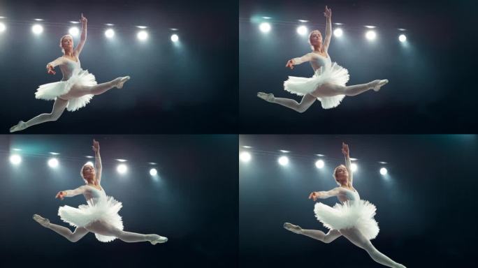 优雅的芭蕾舞演员在表演中表演了一个有力的劈叉跳跃。年轻女性在黑暗的房间里练习惊人的漂亮衣服。电影超级