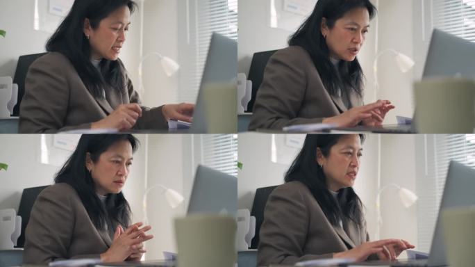 亚洲商务女性，在现代办公室用笔记本电脑进行营销计划和视频会议