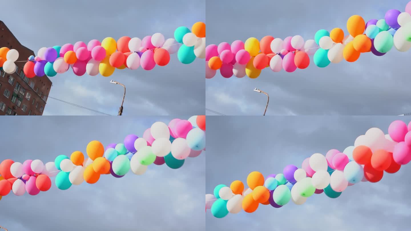 一束长长的彩色气球悬挂在空中