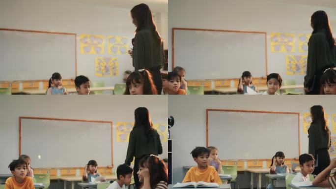 在小学里，老师带领学生走在课桌旁，和孩子们一起上课。