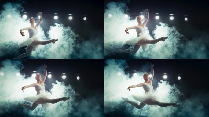 灯光大舞台上的现代芭蕾舞表演。美丽的女芭蕾舞演员在白色的礼服在烟雾中做一个完美的分裂跳跃。超级慢动作