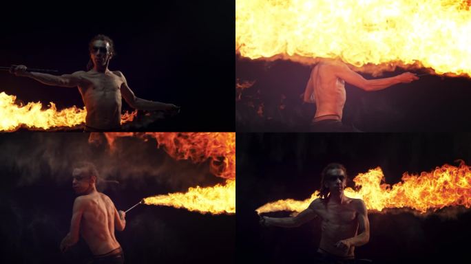 电影超级慢动作镜头。在黑暗的演播室里，火焰表演者拿着点燃的火炬旋转。一名赤裸上身的男性火焰艺术家的肖