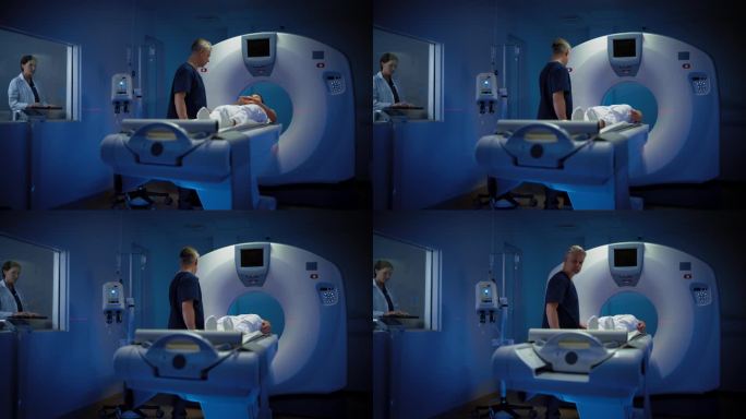 在医学实验室中，女性放射科医生和男性医生控制和监测接受手术的女性患者的MRI或CT扫描。高科技现代医