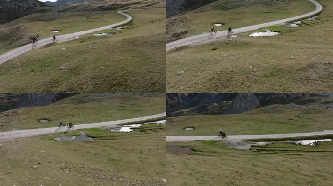 无人机拍摄的骑自行车者攀登高山的照片
