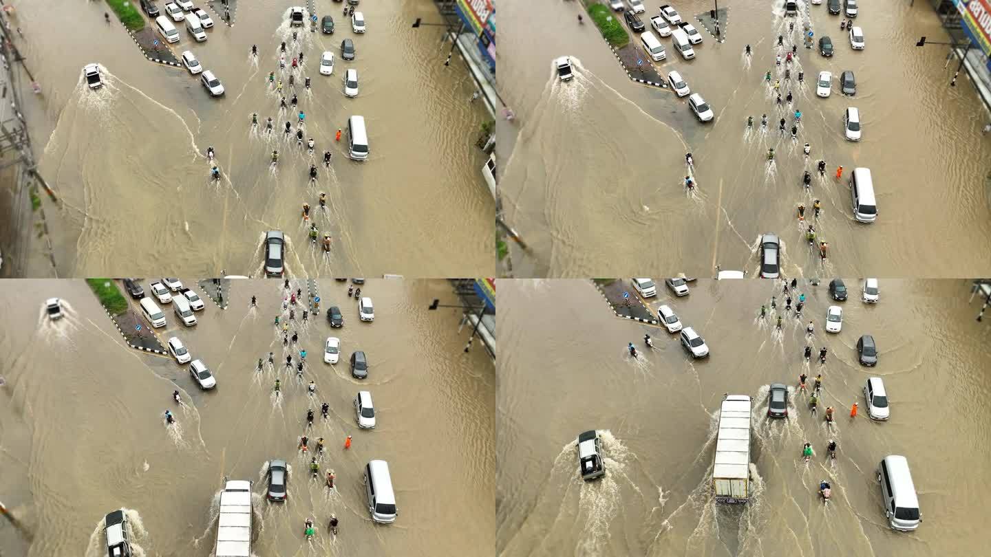 在被水淹没的道路上行驶的交通车辆鸟瞰图。
