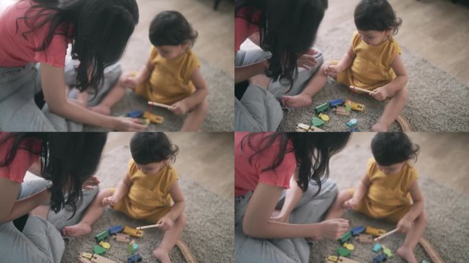 亚洲妈妈和小女孩在客厅里学习玩五颜六色的木制玩具