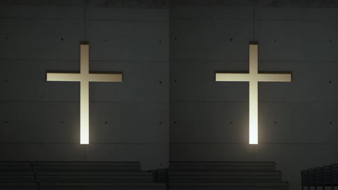 十字架嵌在教堂里一排排椅子后面的墙上。