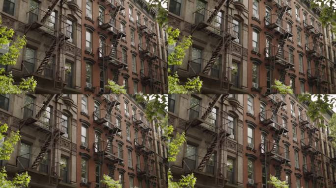 住宅褐石建筑立面在纽约市。旅游视频氛围，镜头与标志性的公寓建筑在一个绿色社区。城市建筑，旅游概念
