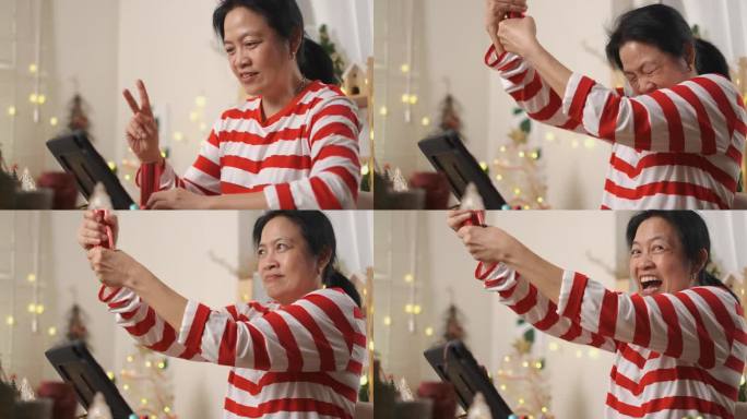 亚洲女性在家中观看直播的新年烟花虚拟活动时，用派对纸射击倒计时