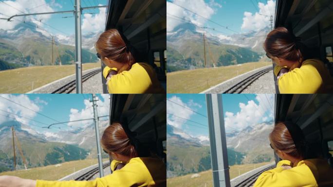 一名女子在火车上向窗外眺望瑞士阿尔卑斯山