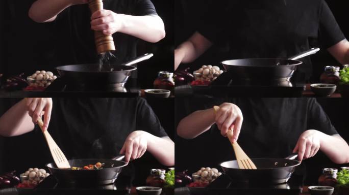 厨师在锅里煎蔬菜特写。女主烹调的菜以烤芦笋、玉米和胡萝卜为主，素菜。辛辣的阿拉伯和墨西哥菜。