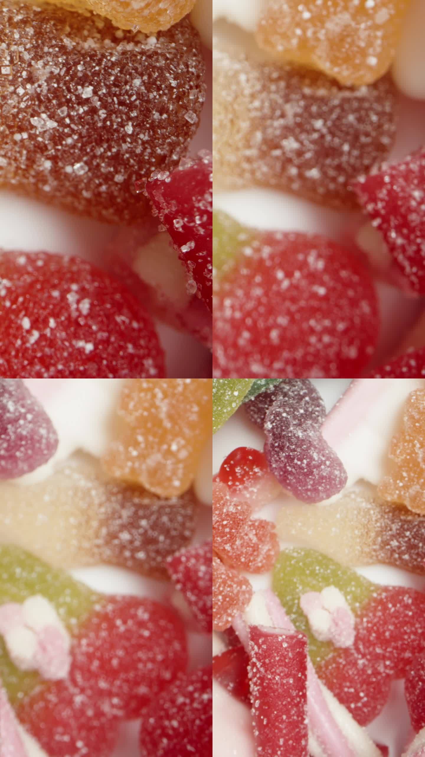 垂直视频。各种形状和口味的彩色软糖的混合物。前视图。多莉滑块极端特写。