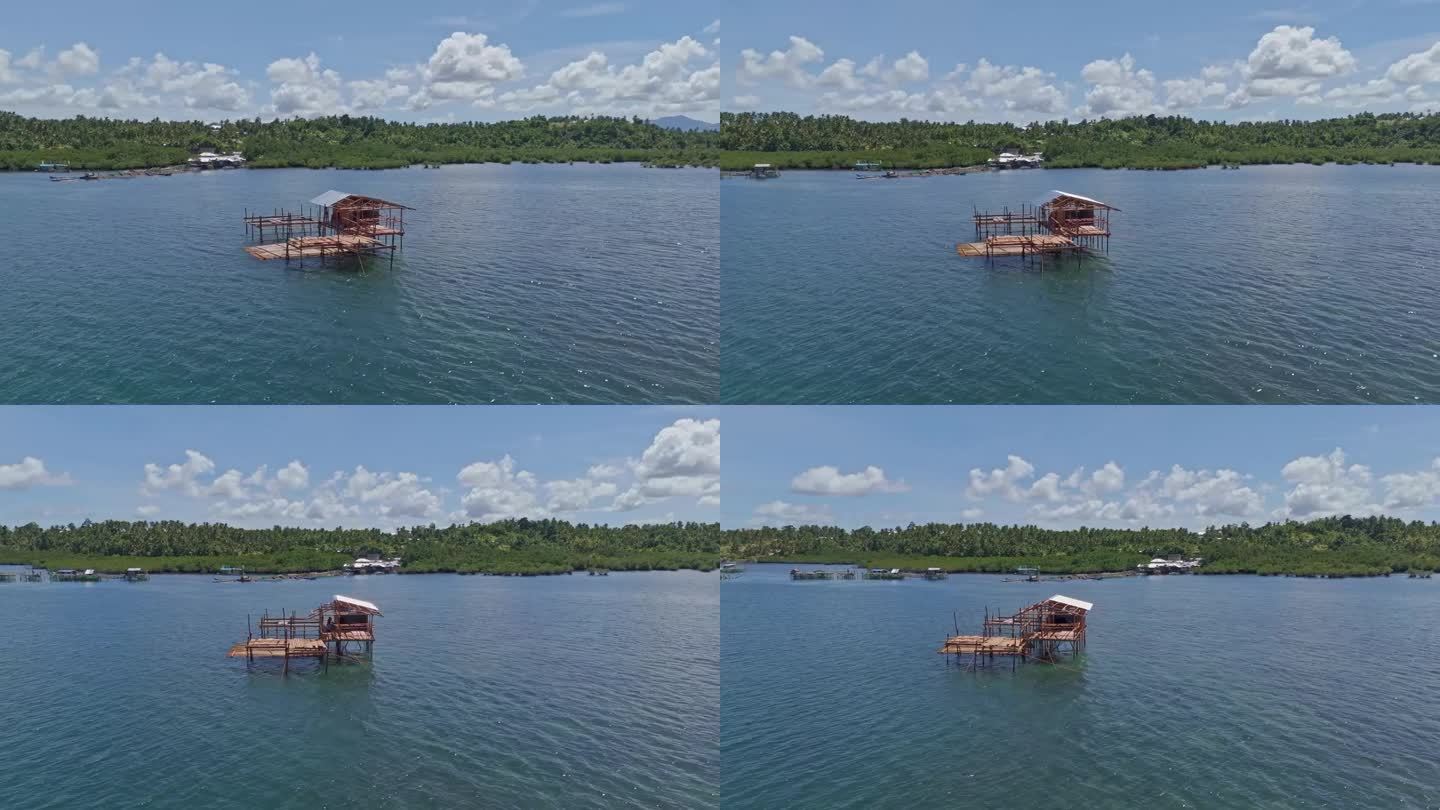 一个独特的木制渔夫小屋，建在浅水区的高跷上，背景是丛林景观。无人机拍摄，白天。巴里巴荣，苏里高市-菲