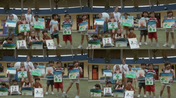 学生和老师的肖像组在学校花园户外展示画板。