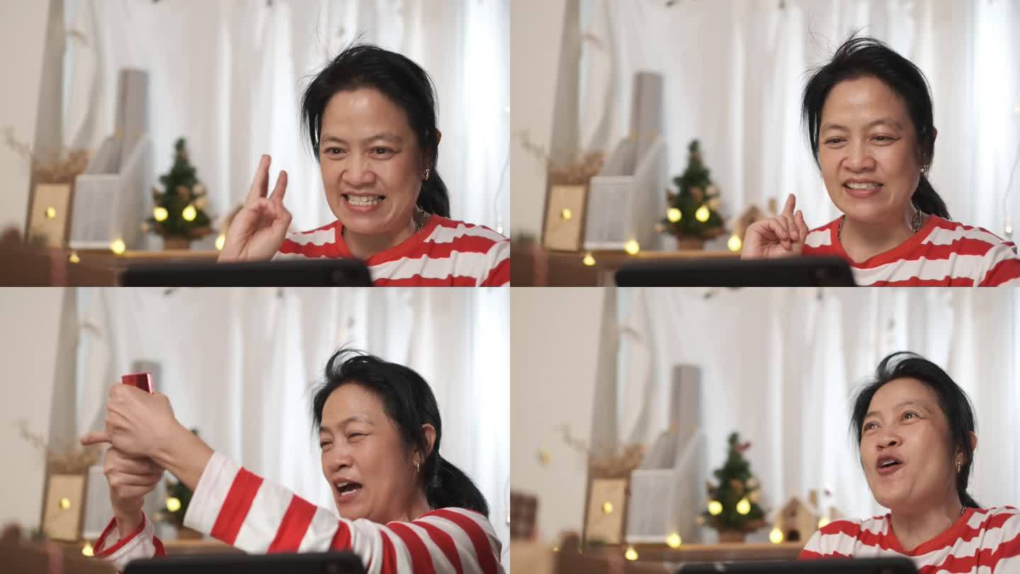 亚洲女性在家中观看直播的新年烟花虚拟活动时，用派对纸射击倒计时