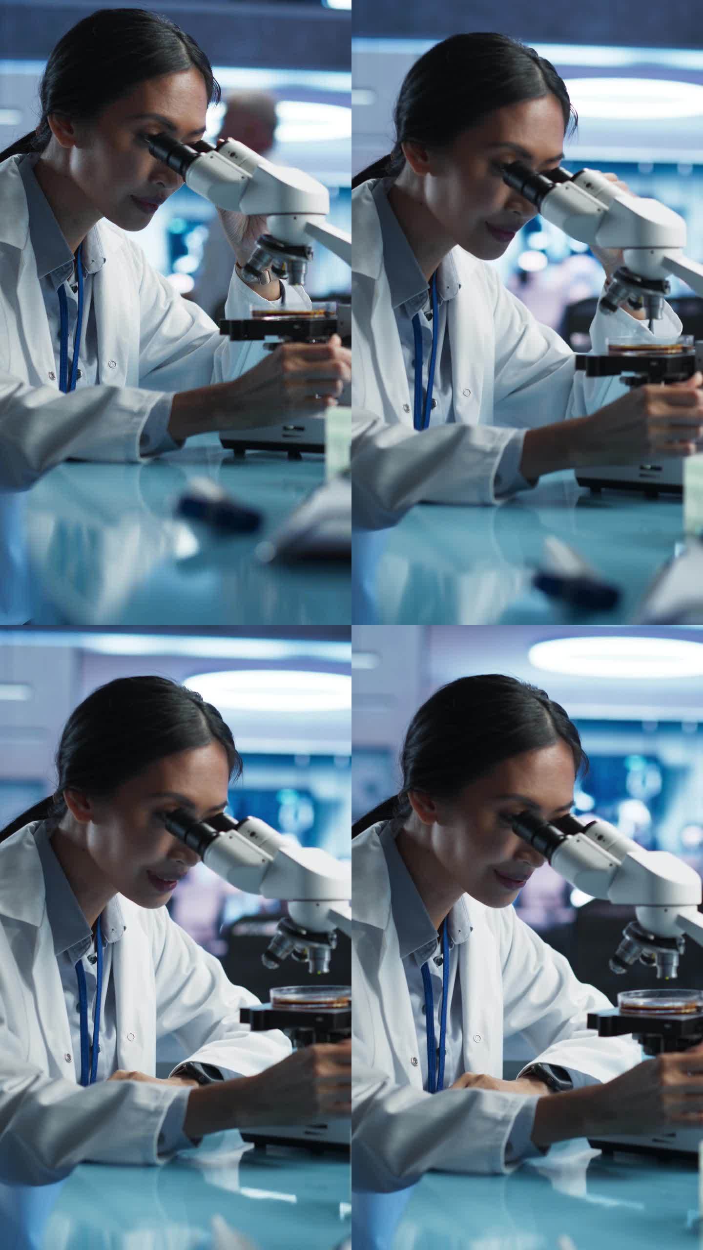 医学发展实验室竖屏:亚洲女科学家用显微镜分析培养皿样品。大型制药实验室与专家进行生物技术研究。