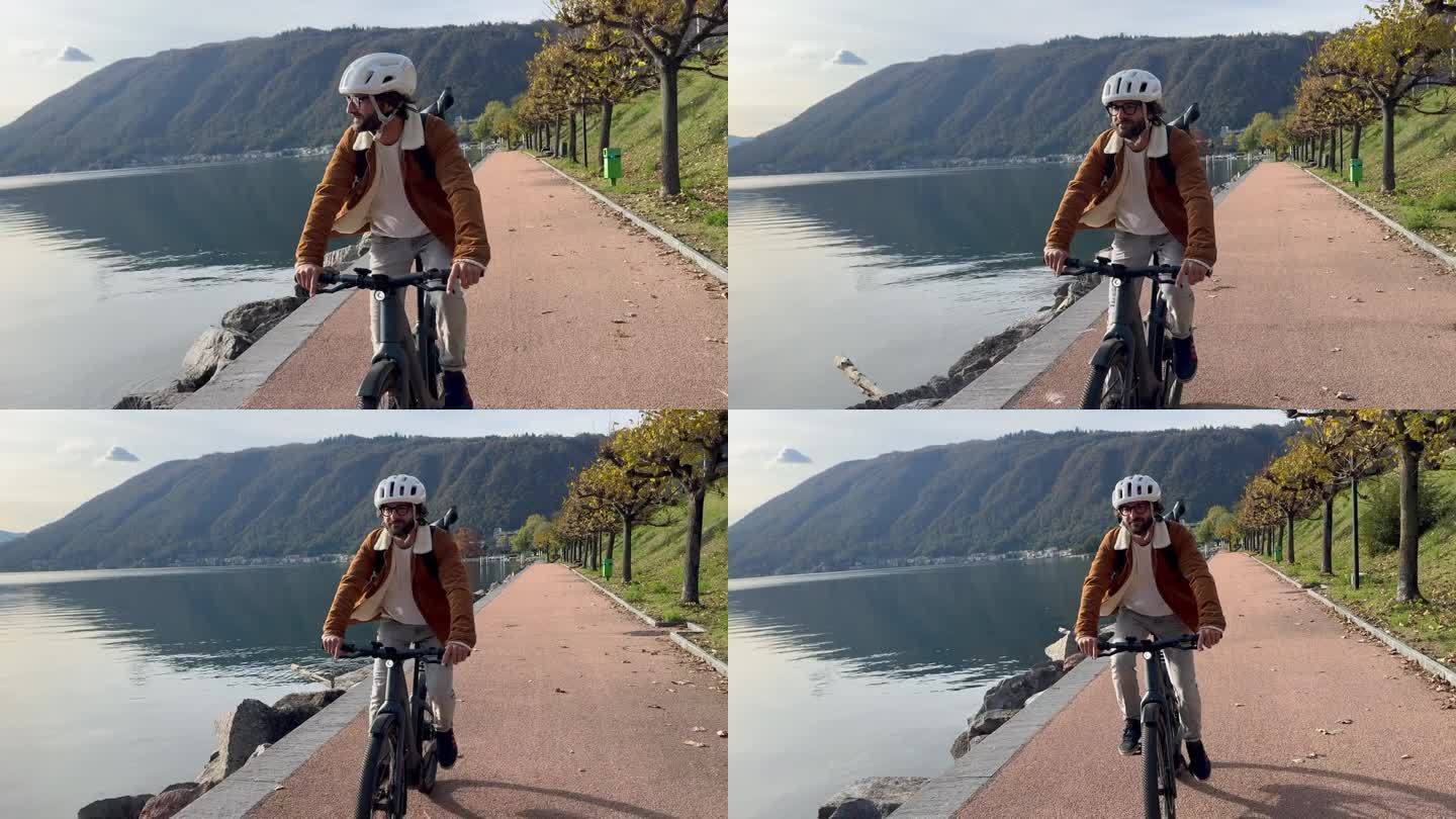 有环保意识的通勤者沿着湖边的小路骑自行车